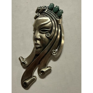 1940s Vintage sterling silver mask brooch with 3 oval green stones